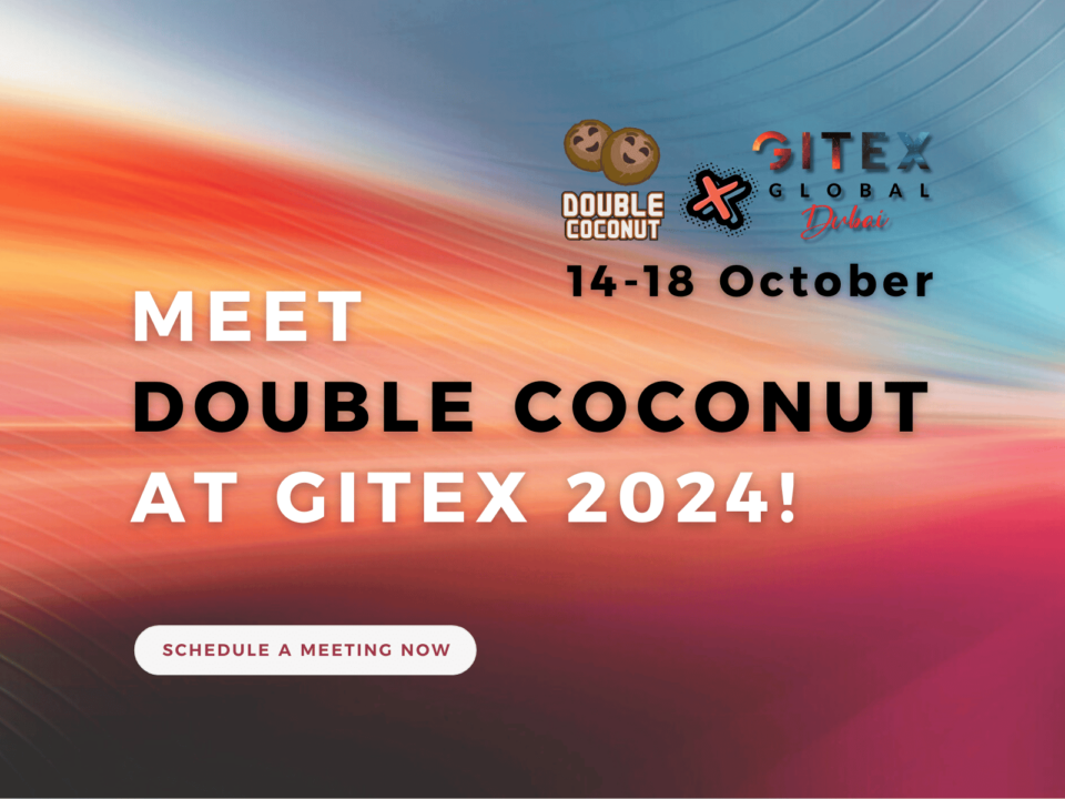 Promotional banner for Double Coconut at GITEX 2024. The banner features a colorful gradient background with shades of orange, red, and blue. It highlights the message 'Meet Double Coconut at GITEX 2024!' along with the event dates, '14-18 October,' and logos for Double Coconut and GITEX Global Dubai. A button at the bottom reads 'Schedule a Meeting Now.